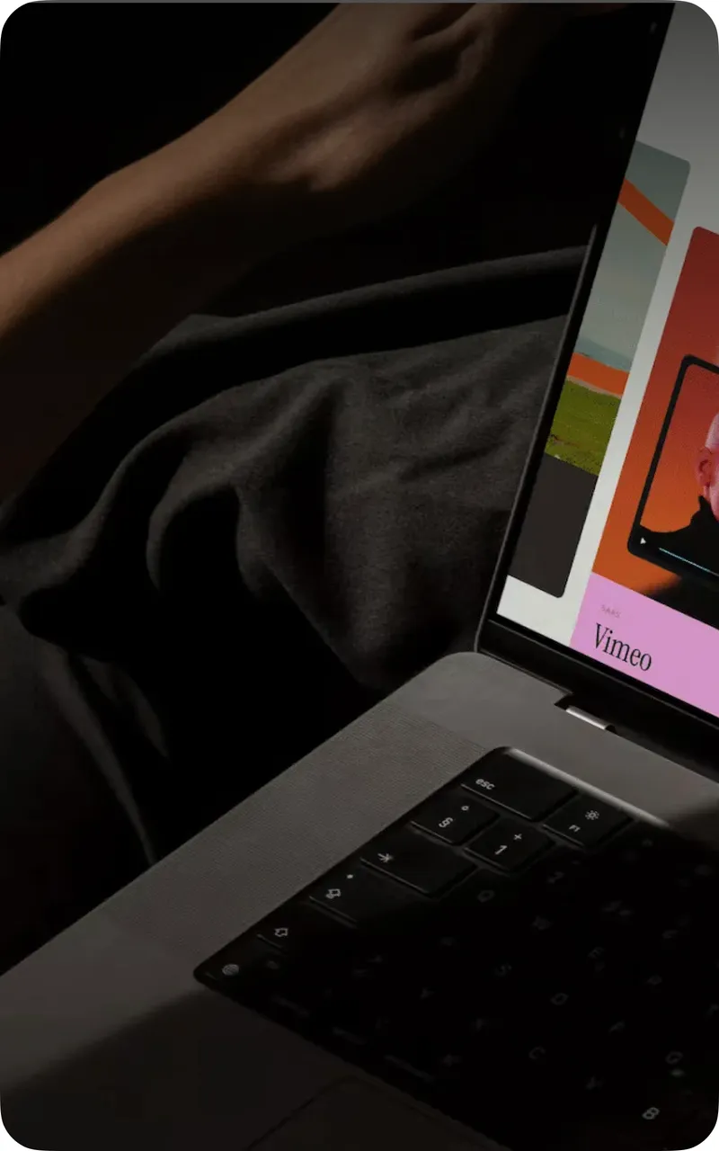 A laptop on a lap, a creator platform open on screen